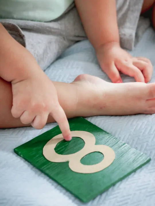 child using montessori sandpaper numbers.