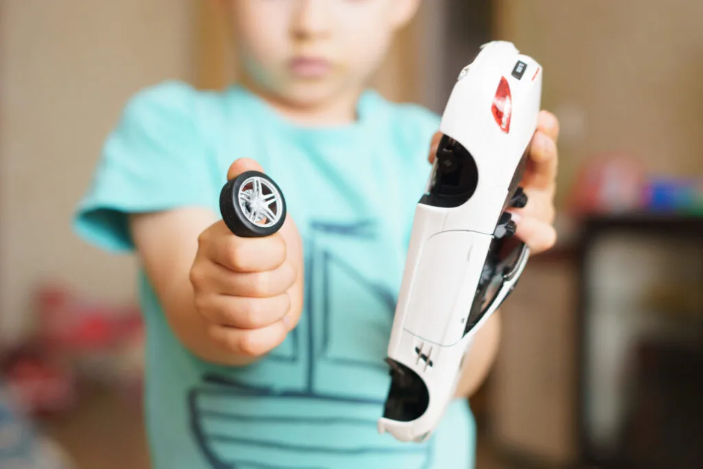 child with broken toy as a natural consequence.