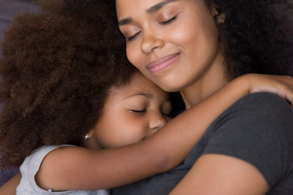 mother holding child and smiling.