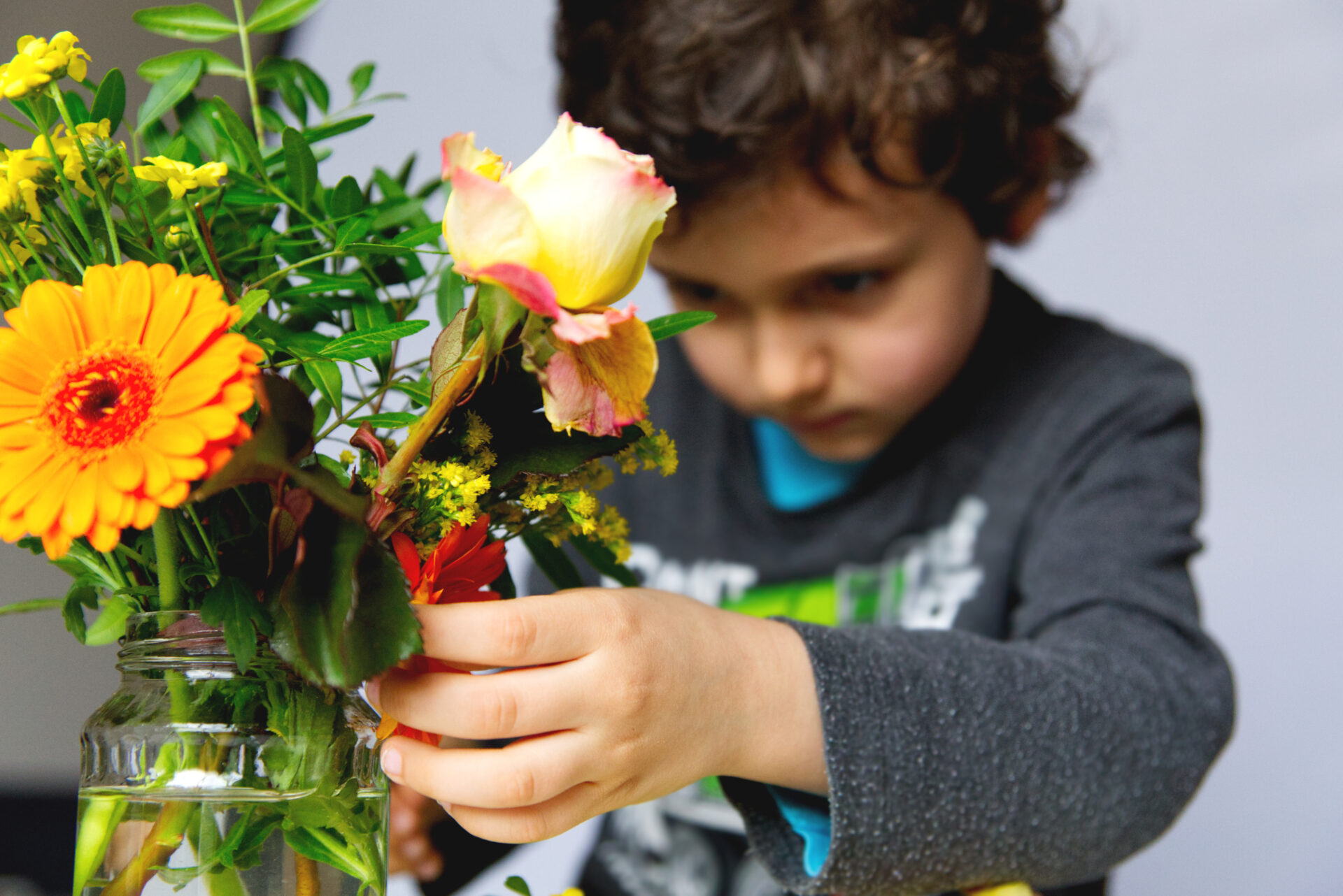child doing montessori flower arranging activity.