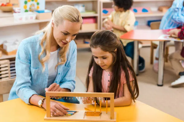 good montessori teacher working with kids.