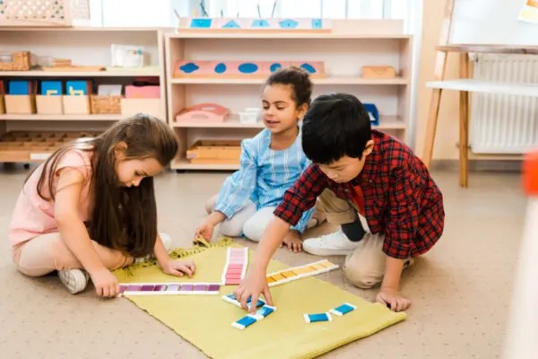 children ina montessori classroom working with the color tablets.