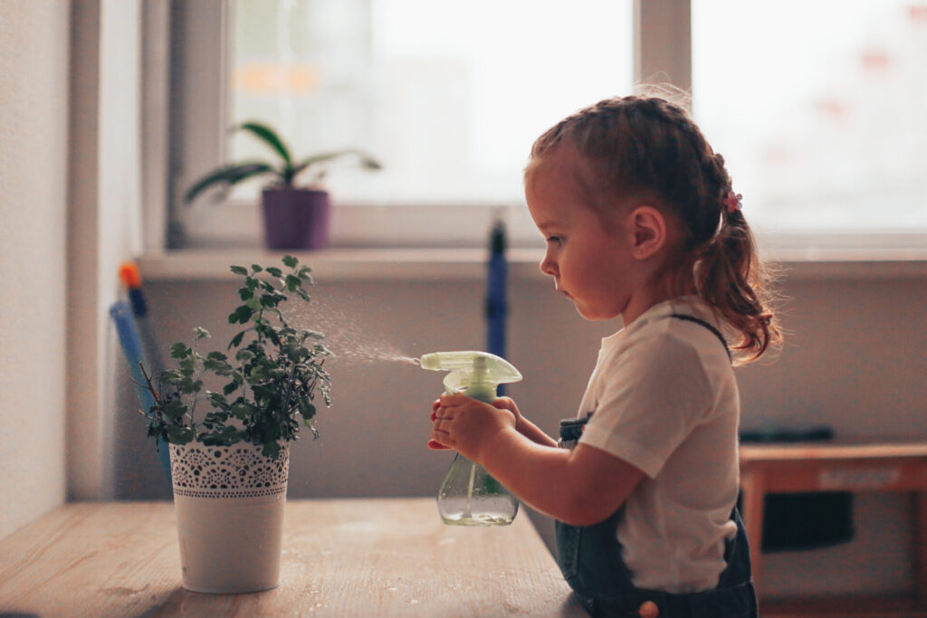 child caring for a plant.