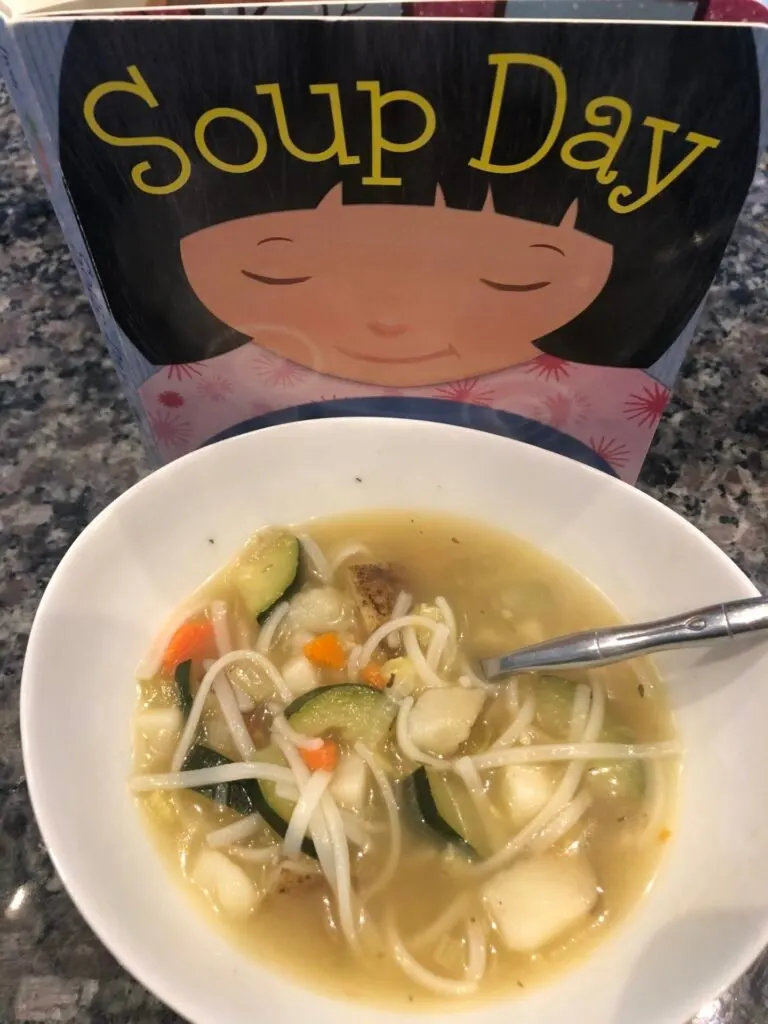 Cooking activities for toddlers inspired by books: Soup Day book with bowl of vegetable soup.