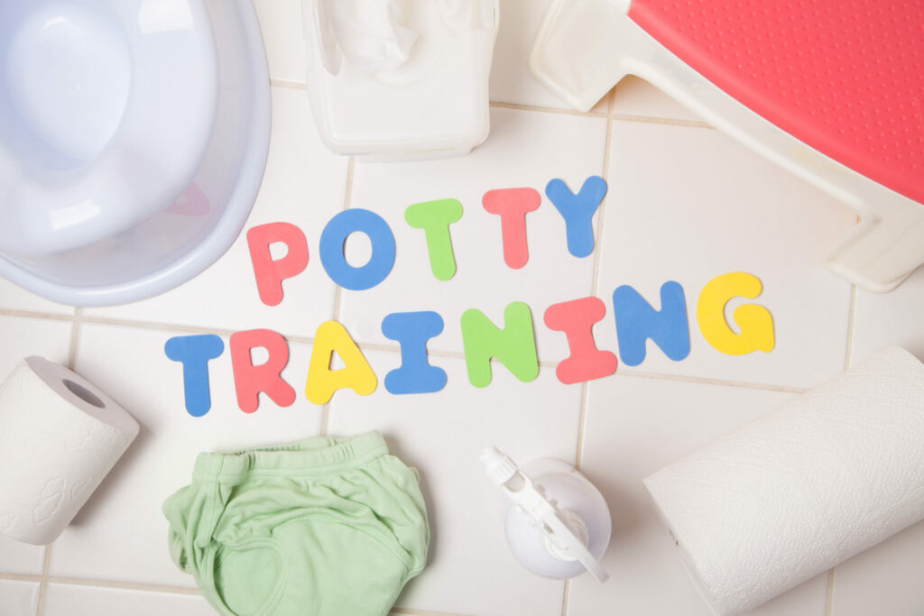 potty training letter near diaper and potty seat.