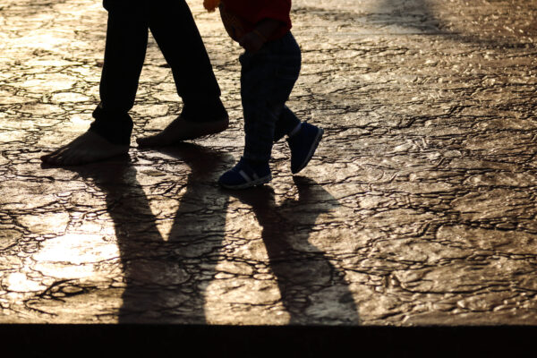 child following parent, shadows.