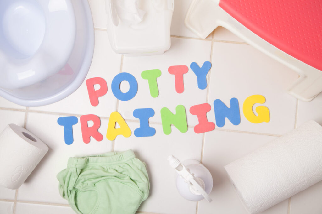potty training letter near diaper and potty seat.