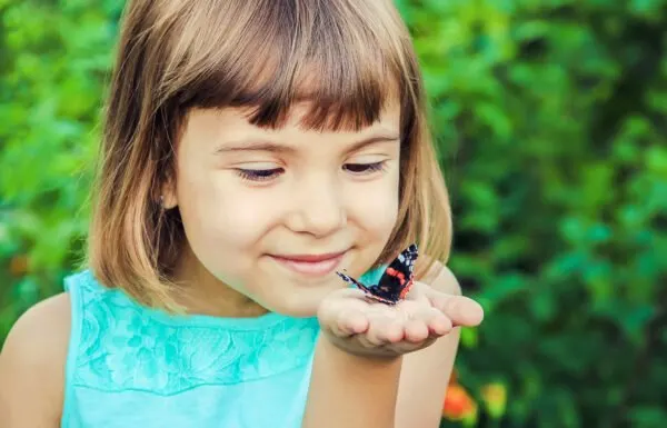 child holding butterfly.