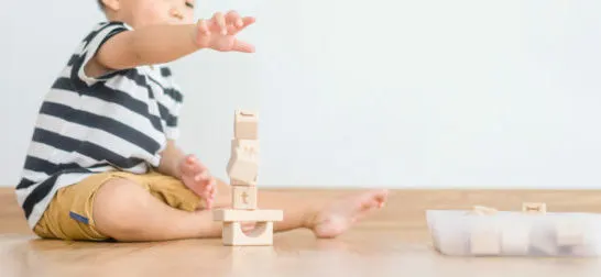 image of toddler playing with montessori toddler toys.