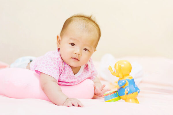 image of baby during tummy time on a tummy time pillow.