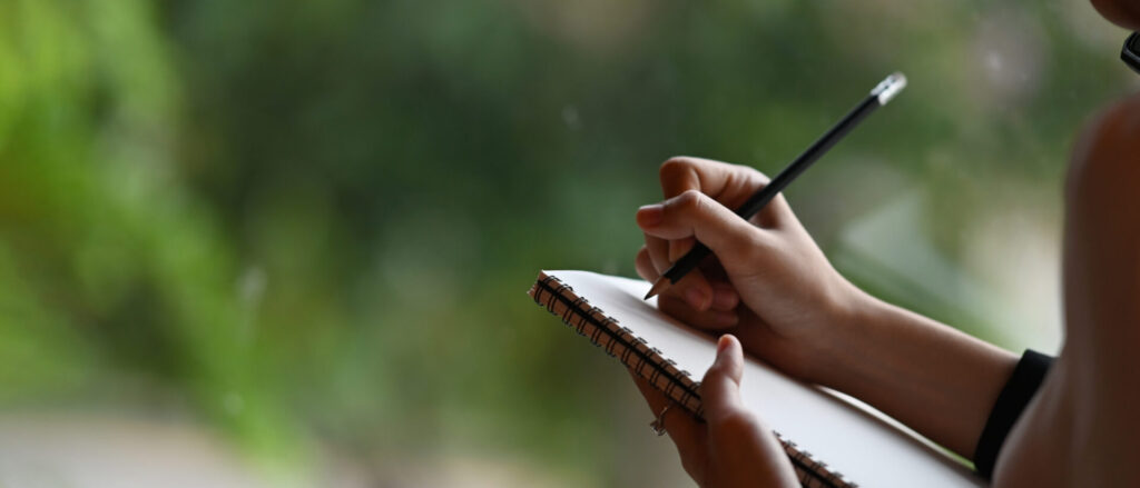 image of woman making Montessori observation record.