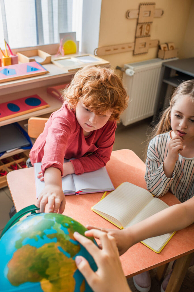 image of children taking part in 3 period lesson in Montessori.