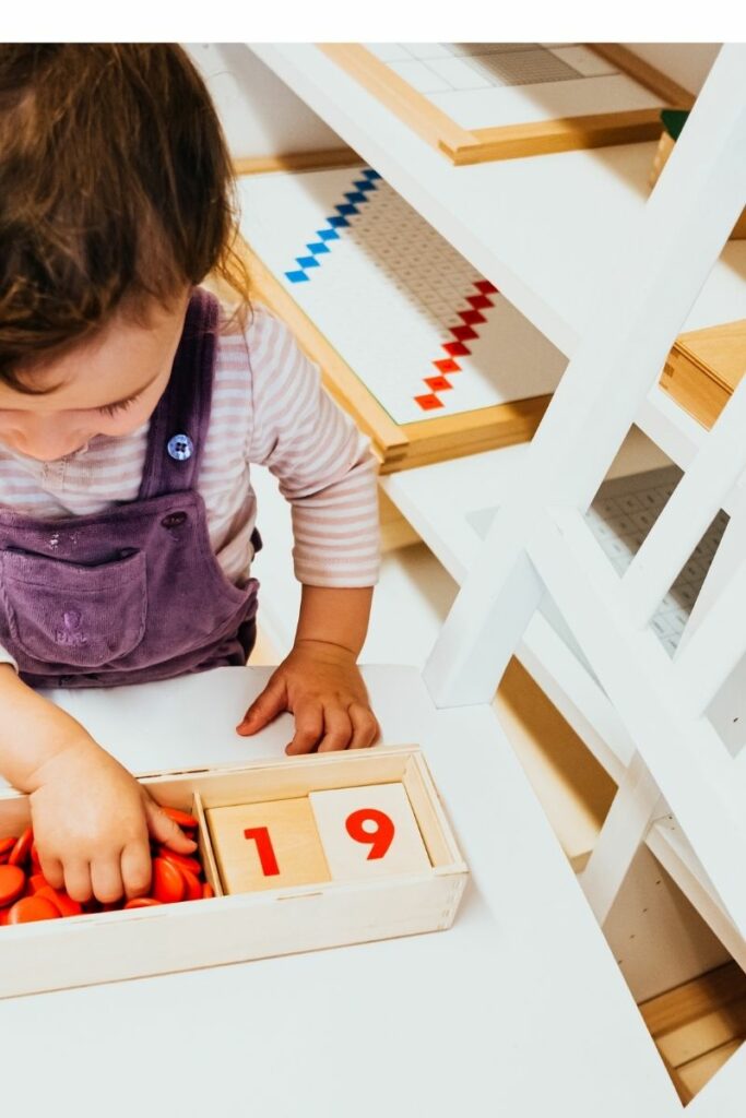image of child working with Montessori cards and counters.