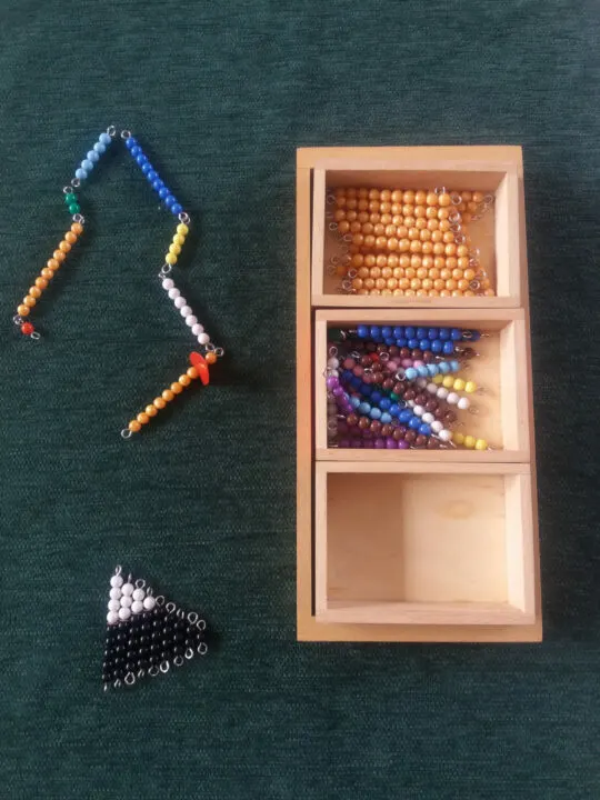 image of colored bead bars laid out for Montessori Snake Game.