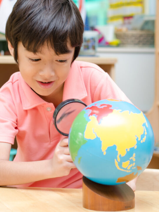 image of child working with the Montessori colored globe.
