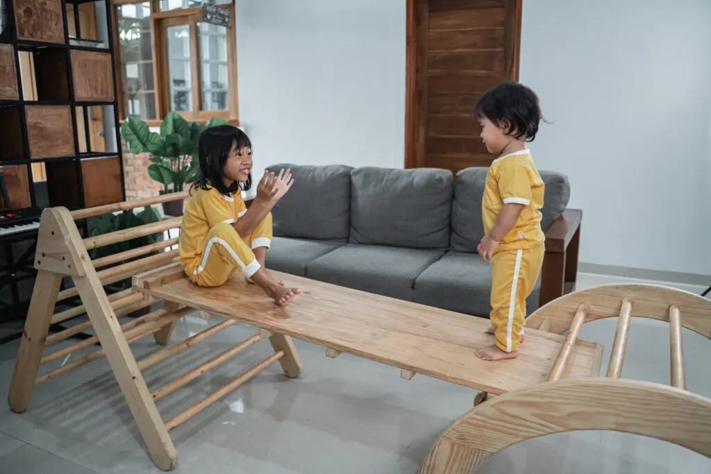 image of 2 children playing on montessori gross motor toys.