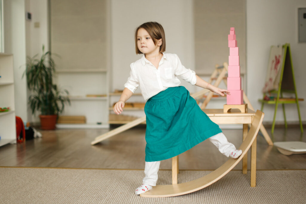 image of a child playing on a montessori balance board.