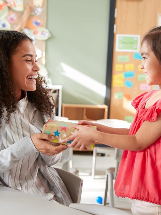 image of a child giving a montessori teacher a gift.