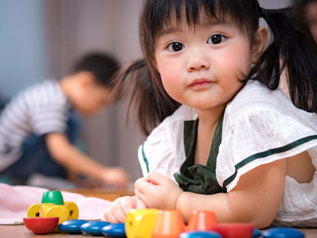 image of a Montessori 3-year-old playing with toys.