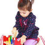 image of child playing with wooden hammering toys.