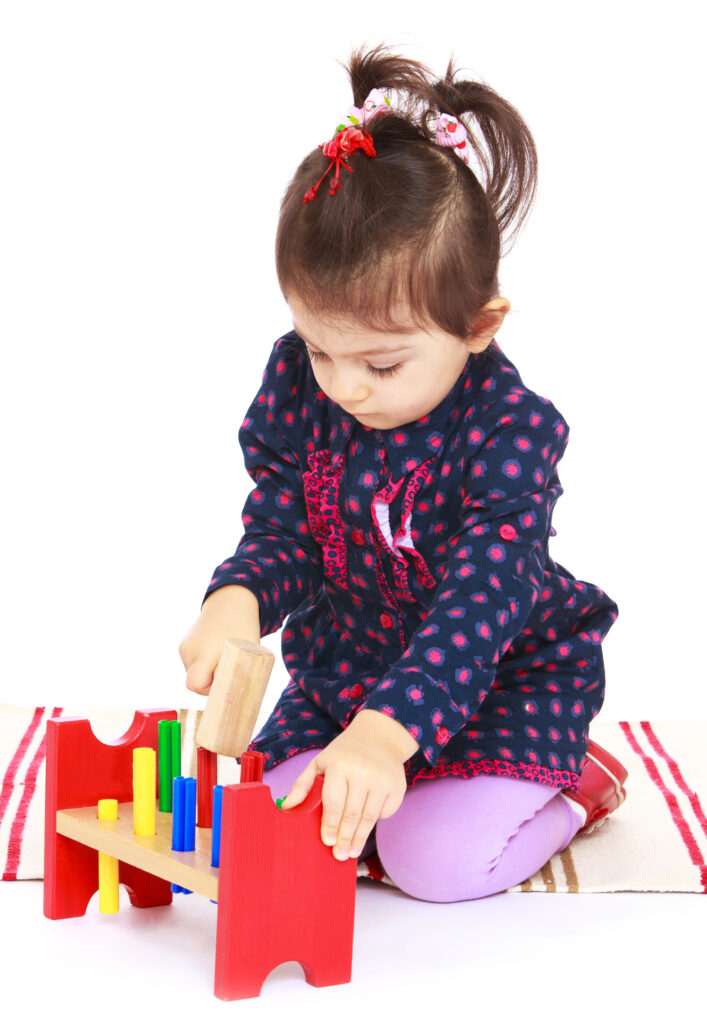 image of child playing with wooden hammering toys.