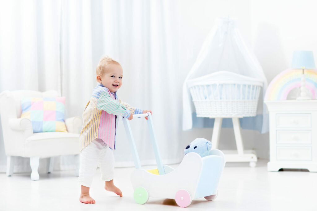 image of child pushing a wooden push walkers.