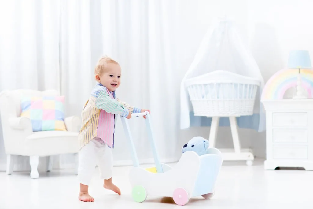 image of child pushing a wooden push walkers.