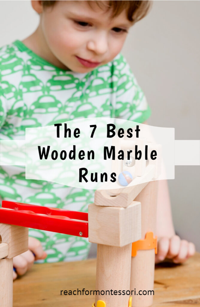 image of child playing with toy with text overlay reading 7 best wooden marble runs.