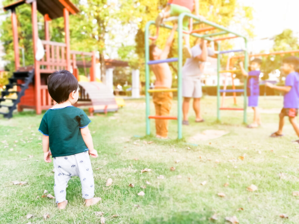 toddler exhibiting onlooker play at playground.