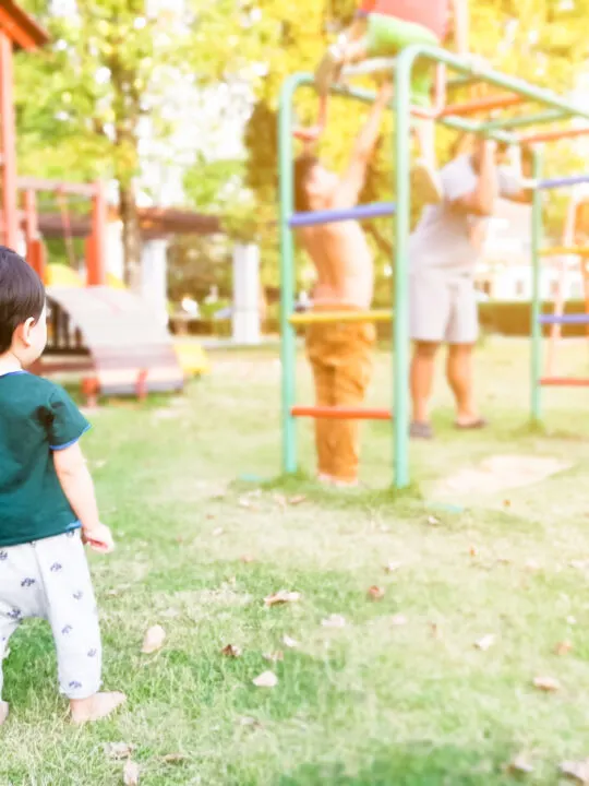 toddler exhibiting onlooker play at playground.