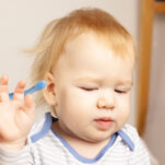 image of child refusing to brush his teeth. Montessori teeth brushing tips will help him.