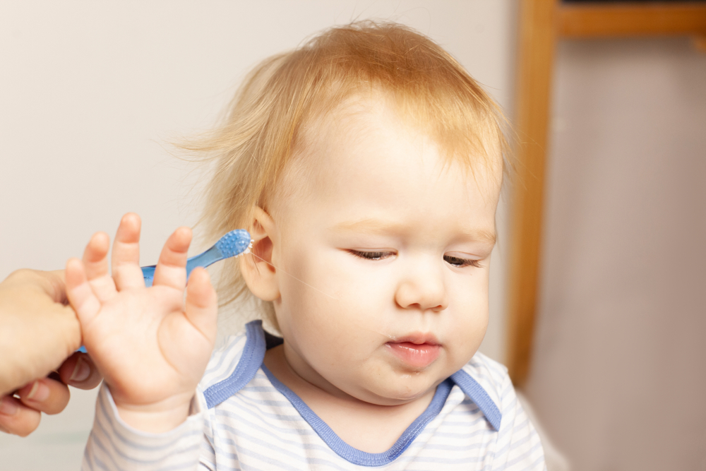 image of child refusing to brush his teeth. Montessori teeth brushing tips will help him.