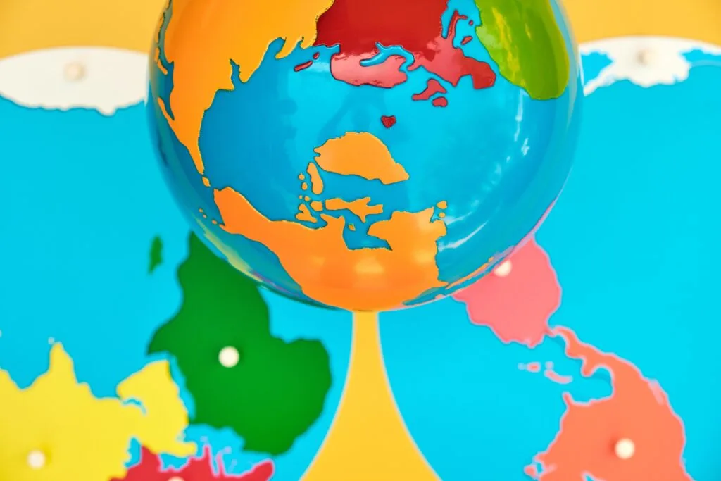 Image of Montessori geography materials, the colored globe and the continent map puzzle.