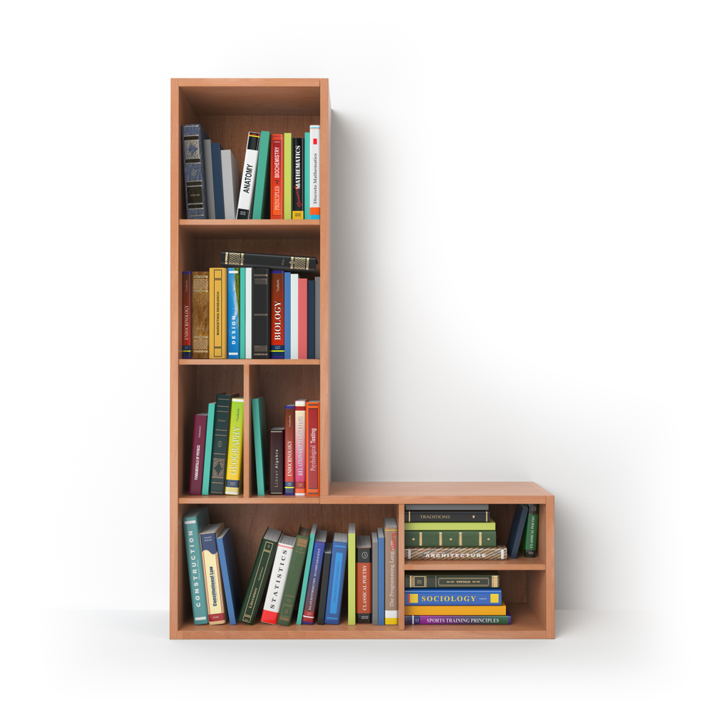 Image of books in book case shaped like the letter L.