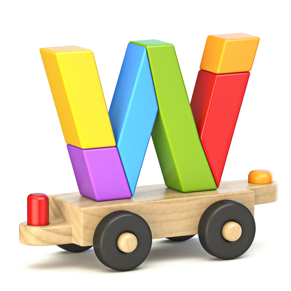 image of letter W built from wooden toys, on top of wooden train.