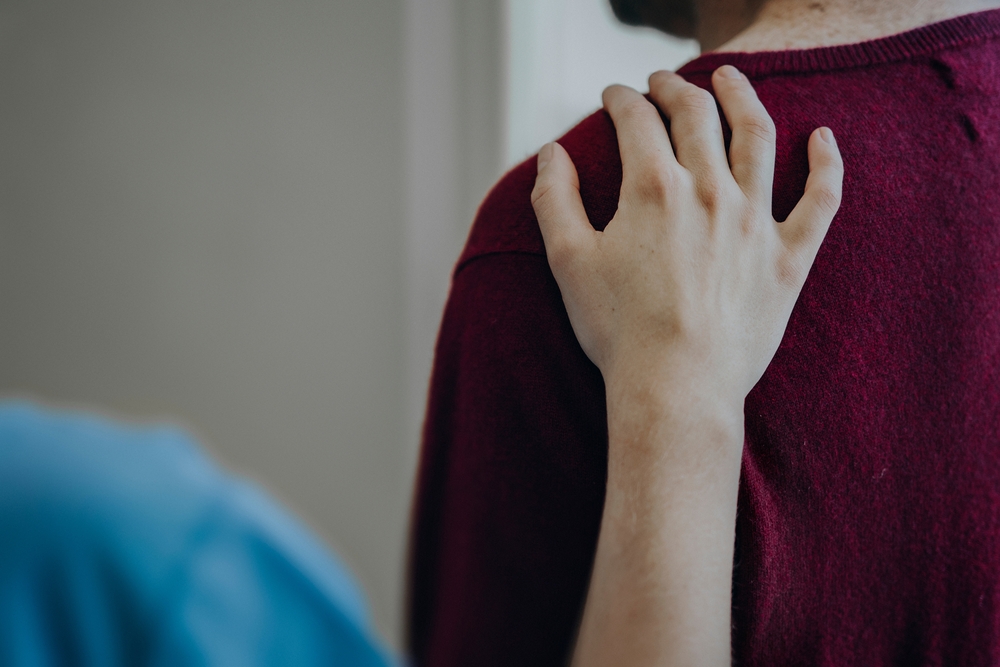 Image of child placing hand on should to get someone's attention and saying excuse me.