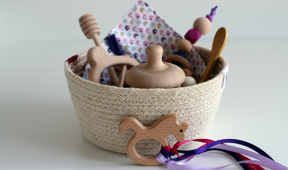 Image of Montessori treasure basket filled with wooden baby toys.