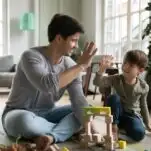 image of father and son building with construction play toys.