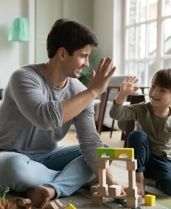 image of father and son building with construction play toys.